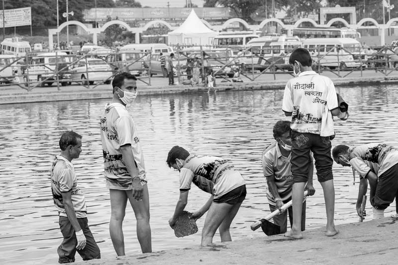 Volunteers cleaning the Ghats on the banks of river Godavari during Kumbh in Nashik, Maharashtra